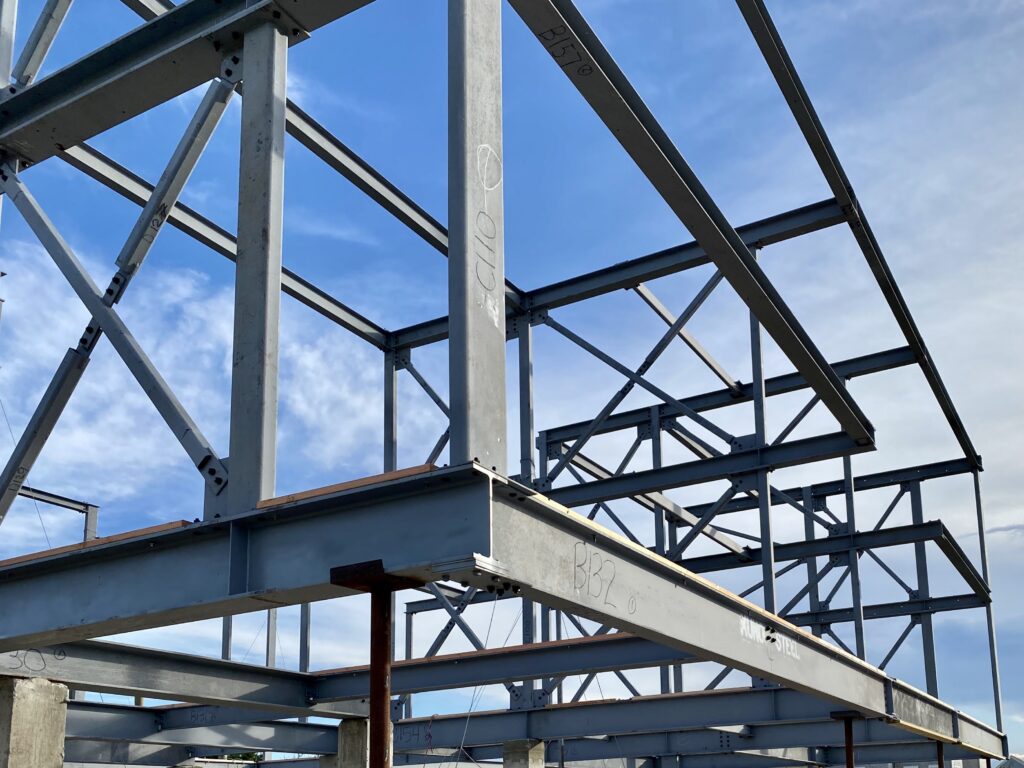 Picture of a steel building frame backed by a blue sky